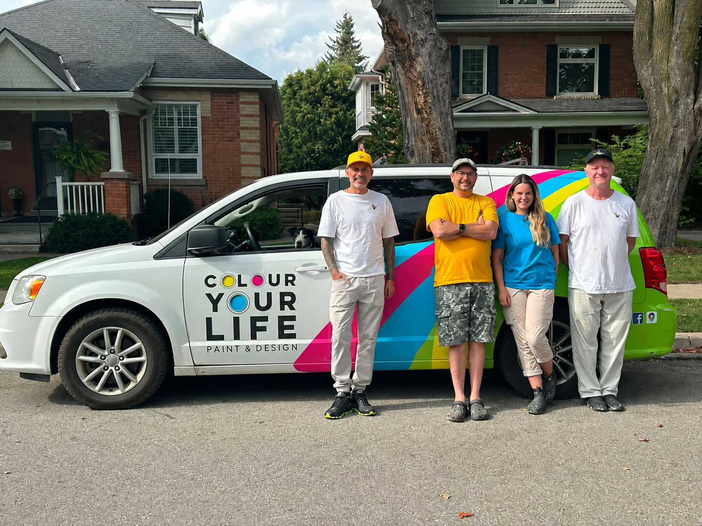 The Colour Your Life painting crew of five standing together beside the company's branded van